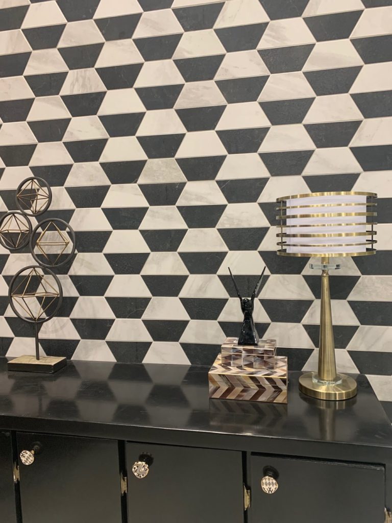 geometric pattern wall design with black cupboards