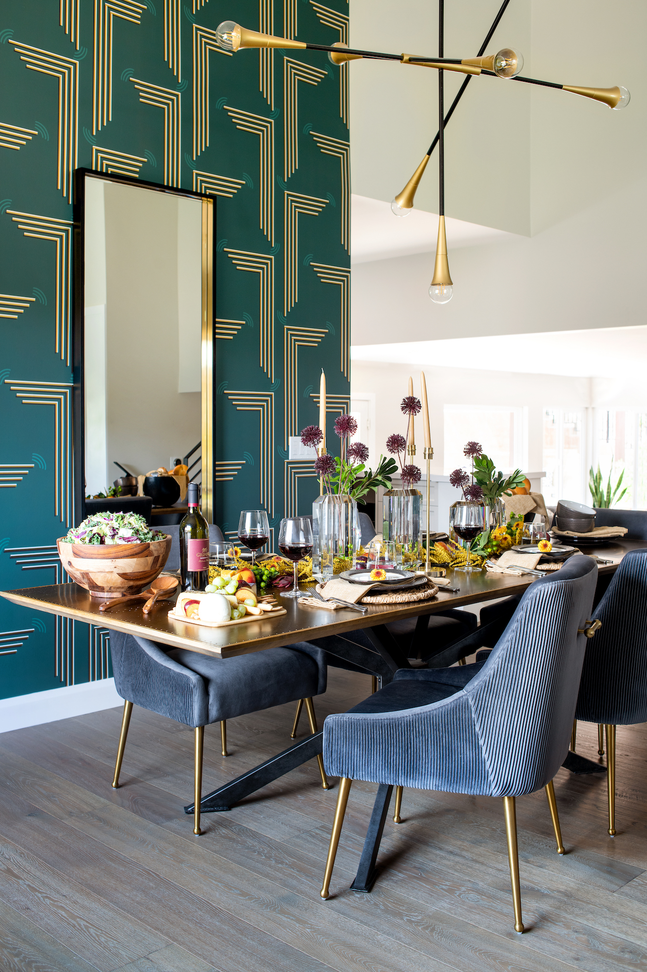 minimal design golden dining table with comfy blue chairs and food on top